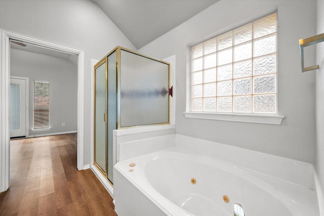 bathroom featuring hardwood / wood-style flooring, vaulted ceiling, and independent shower and bath