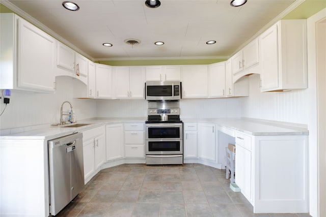 kitchen with white cabinetry, sink, backsplash, light tile patterned floors, and stainless steel appliances