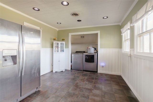 laundry area featuring ornamental molding and washing machine and dryer