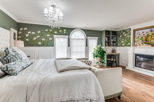 bedroom with crown molding, a notable chandelier, and light wood-type flooring