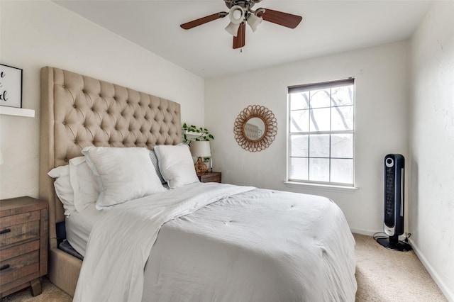 bedroom featuring light colored carpet and ceiling fan