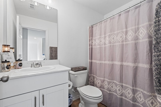 bathroom with vanity, toilet, and a shower with shower curtain