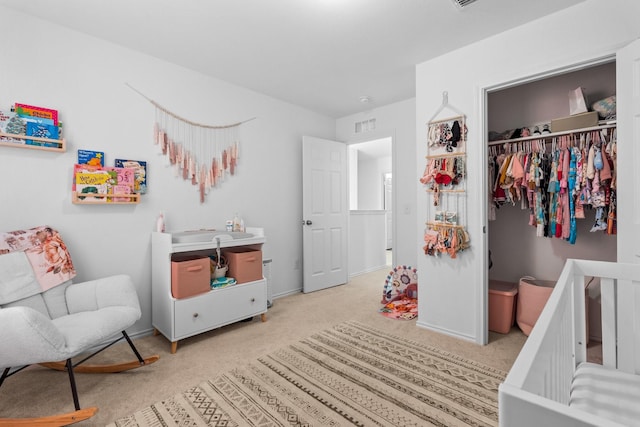 bedroom with light colored carpet and a closet