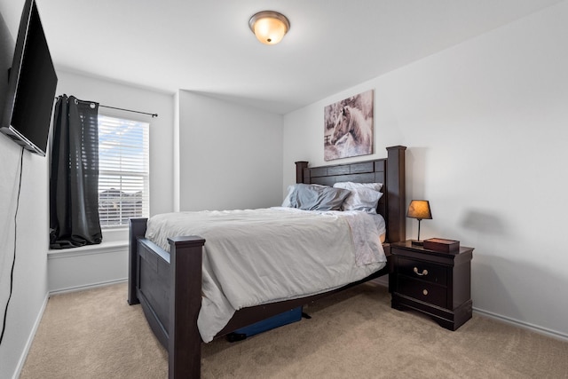 bedroom featuring light carpet