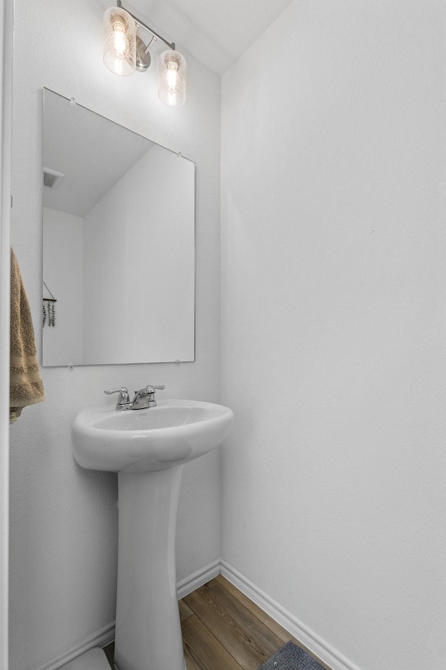 bathroom with hardwood / wood-style flooring