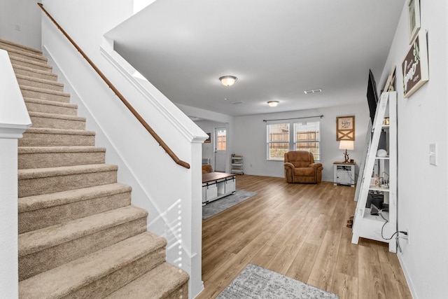 stairway with wood-type flooring