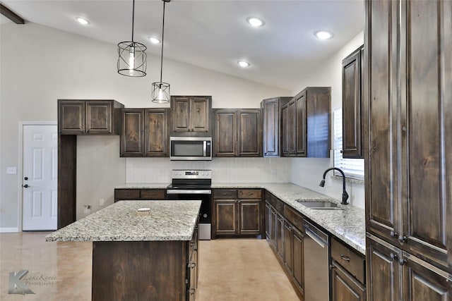 kitchen featuring sink, appliances with stainless steel finishes, hanging light fixtures, dark brown cabinetry, and a kitchen island