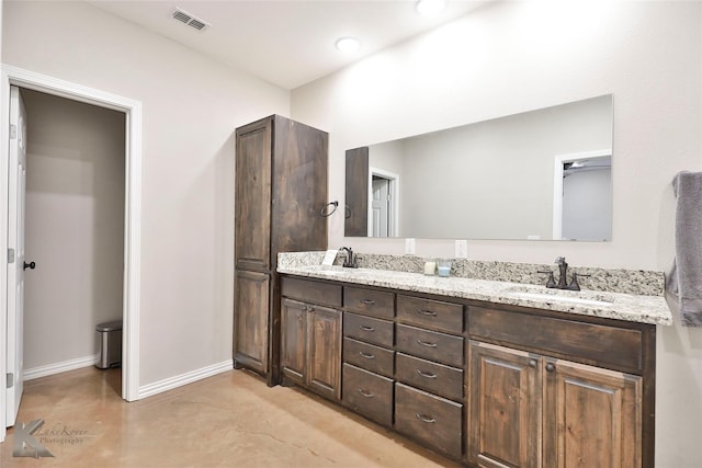 bathroom with vanity and concrete floors