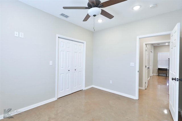 unfurnished bedroom featuring concrete floors, ceiling fan, and a closet