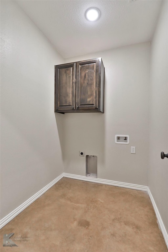 washroom with washer hookup, cabinets, hookup for an electric dryer, and a textured ceiling