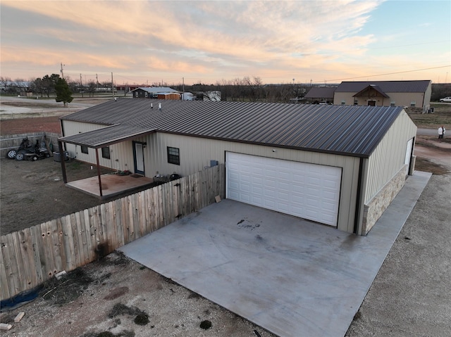 view of garage at dusk