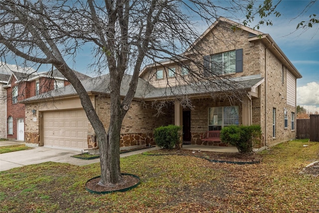 view of front of house with a garage, a front yard, and a porch