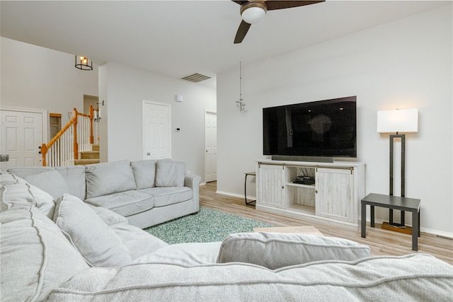 living room with ceiling fan and light wood-type flooring