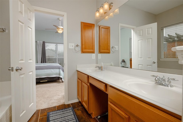 bathroom featuring vanity, a bathing tub, and ceiling fan