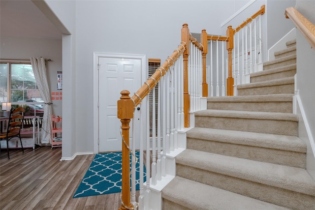 stairs with hardwood / wood-style floors