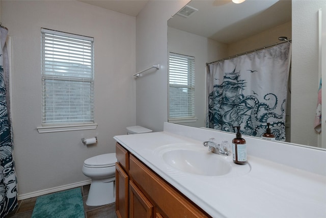 bathroom with vanity, toilet, and tile patterned flooring