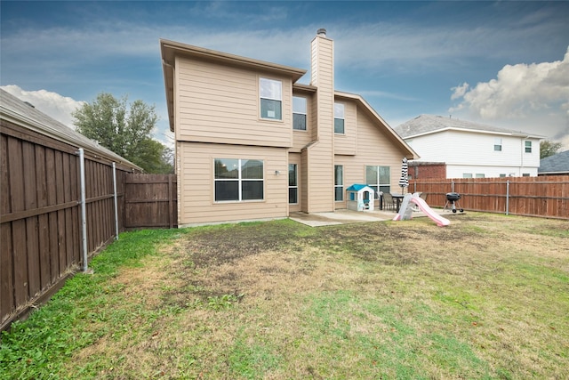 rear view of property featuring a patio area and a lawn