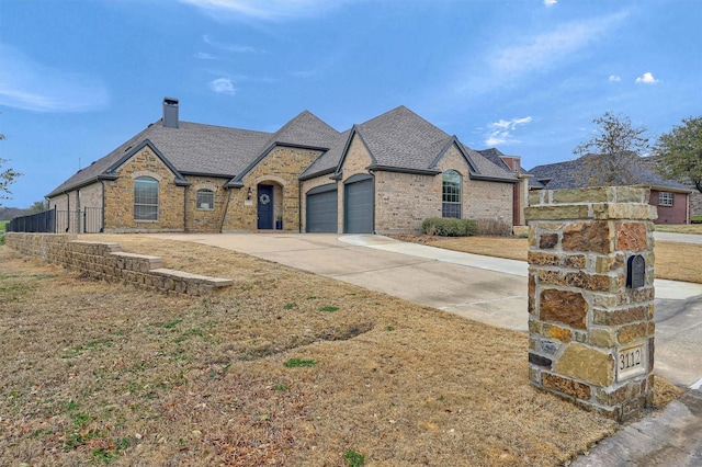 french country inspired facade with a garage