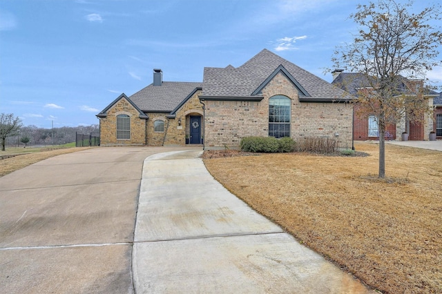 french country style house featuring a front yard