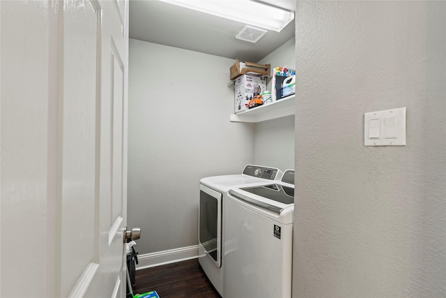 washroom featuring dark hardwood / wood-style flooring and washer and clothes dryer