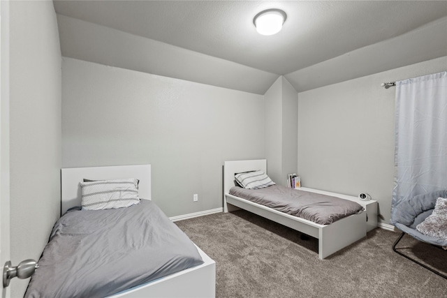 carpeted bedroom with lofted ceiling