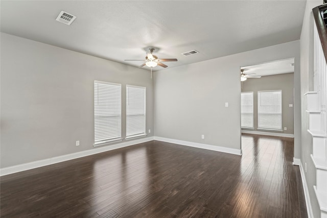 spare room with dark hardwood / wood-style flooring and ceiling fan