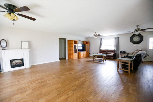 living room featuring hardwood / wood-style flooring and ceiling fan