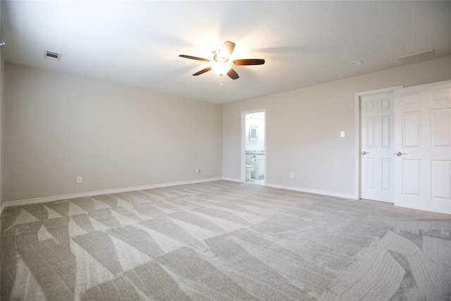 spare room featuring light colored carpet and ceiling fan