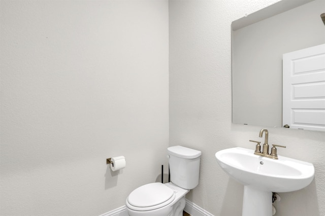 bathroom featuring sink and toilet