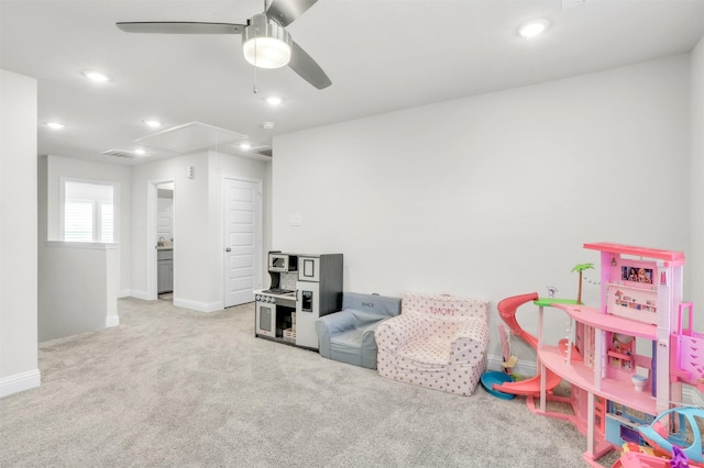 playroom with ceiling fan and light carpet