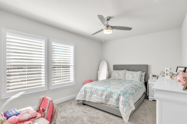 bedroom featuring light colored carpet and ceiling fan