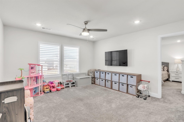 game room with light colored carpet and ceiling fan