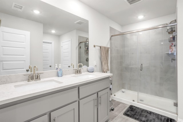 bathroom featuring walk in shower and vanity