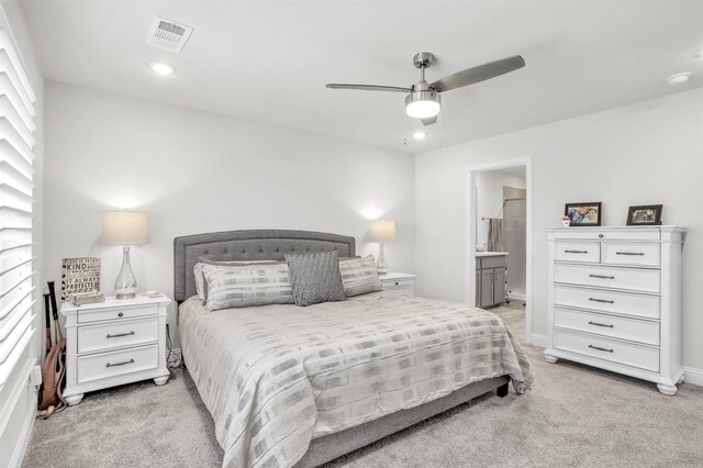 carpeted bedroom with ceiling fan and connected bathroom