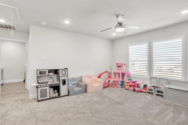 game room with light carpet and ceiling fan