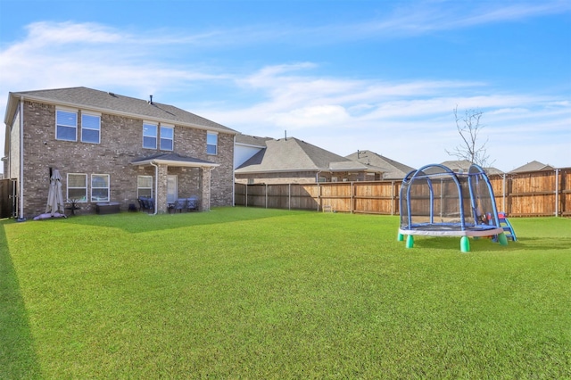 view of yard with a trampoline