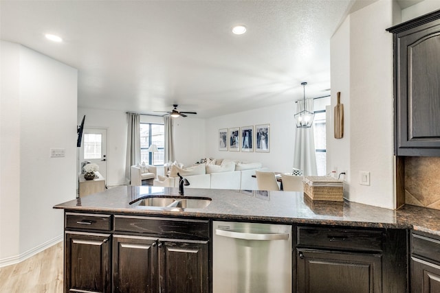 kitchen featuring dark brown cabinetry, sink, dishwasher, and light wood-type flooring