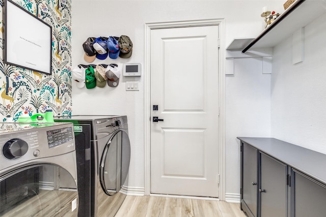 laundry area with cabinets, separate washer and dryer, and light hardwood / wood-style flooring