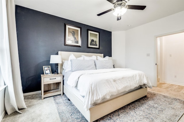 bedroom featuring light colored carpet and ceiling fan