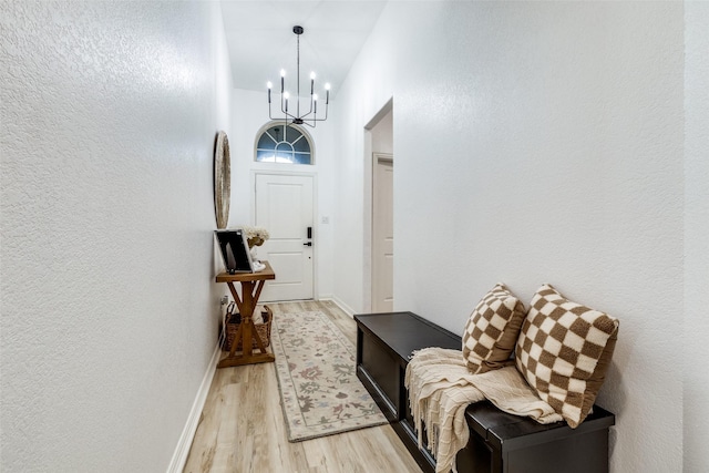 hallway featuring a chandelier and light wood-type flooring