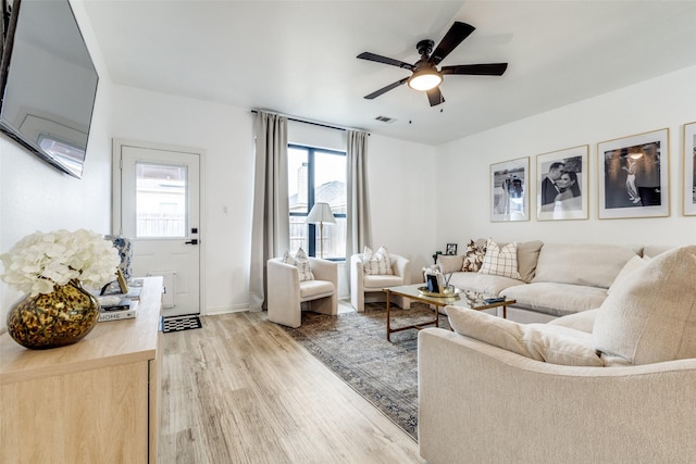 living room featuring ceiling fan and light hardwood / wood-style flooring