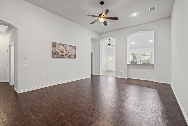 unfurnished room featuring visible vents, baseboards, recessed lighting, arched walkways, and a ceiling fan