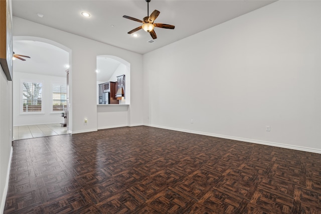 spare room featuring recessed lighting, arched walkways, baseboards, and ceiling fan