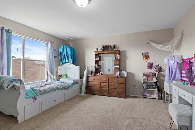 bedroom with light carpet and a textured ceiling