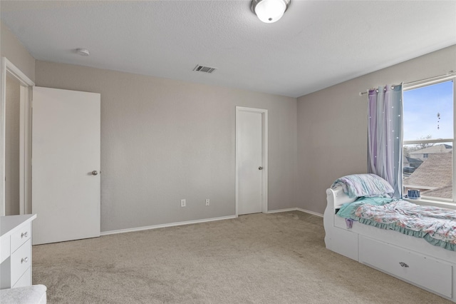 carpeted bedroom featuring a textured ceiling