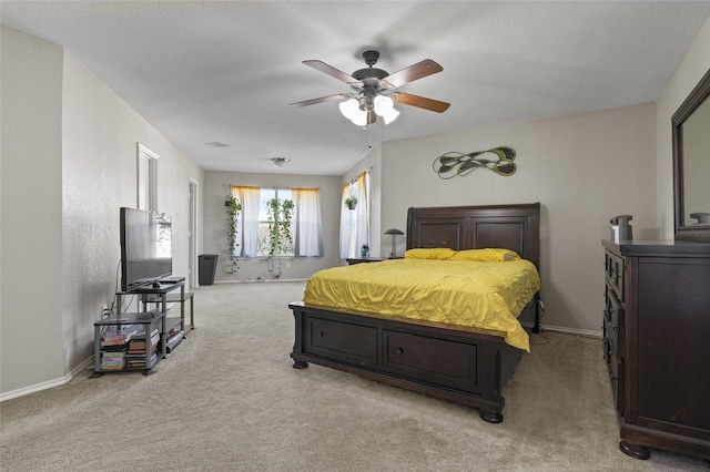 carpeted bedroom with a textured ceiling and ceiling fan