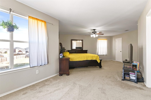 bedroom with light colored carpet and ceiling fan