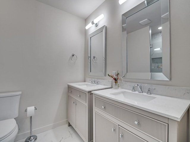 bathroom with toilet, marble finish floor, baseboards, and vanity