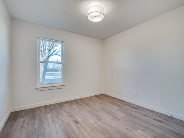 empty room with wood finished floors and baseboards