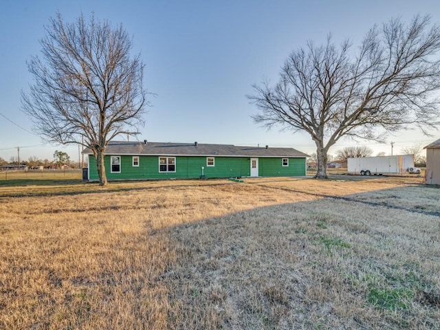 rear view of house featuring a yard